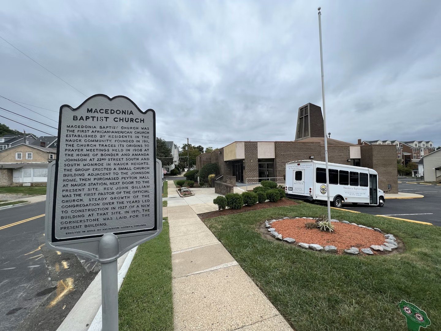 The Arlington County historical marker in front of Macedonia Baptist Church, with the church building behind it.