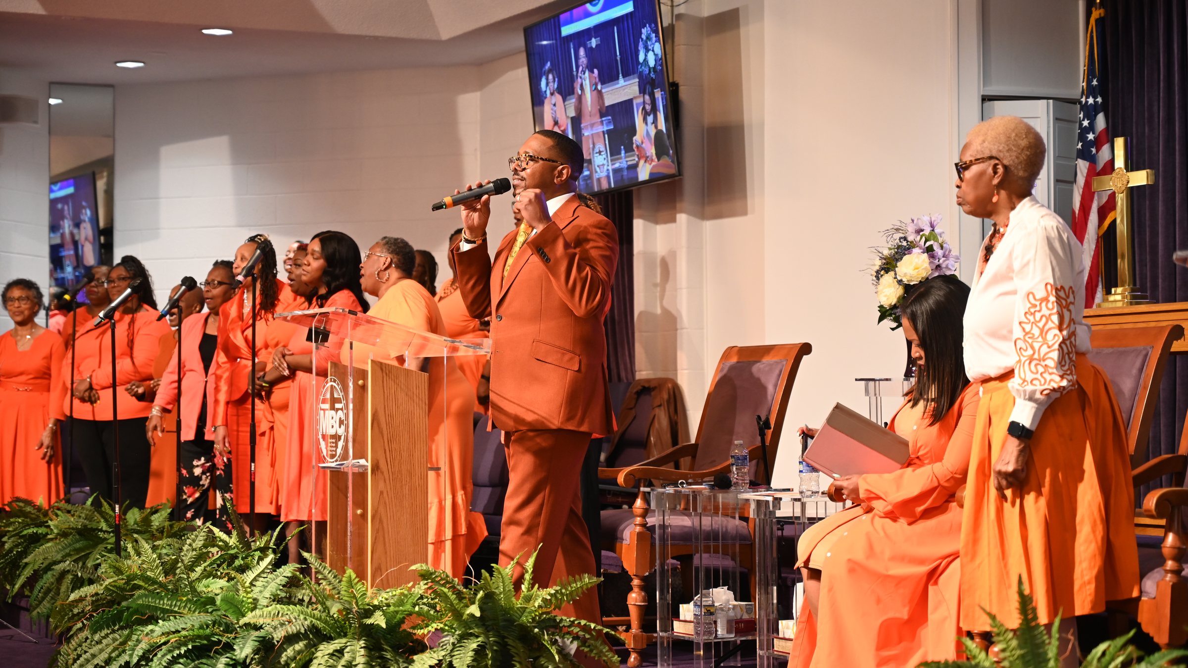Pastor Harcum leading worship with the praise team on Women's Day.
